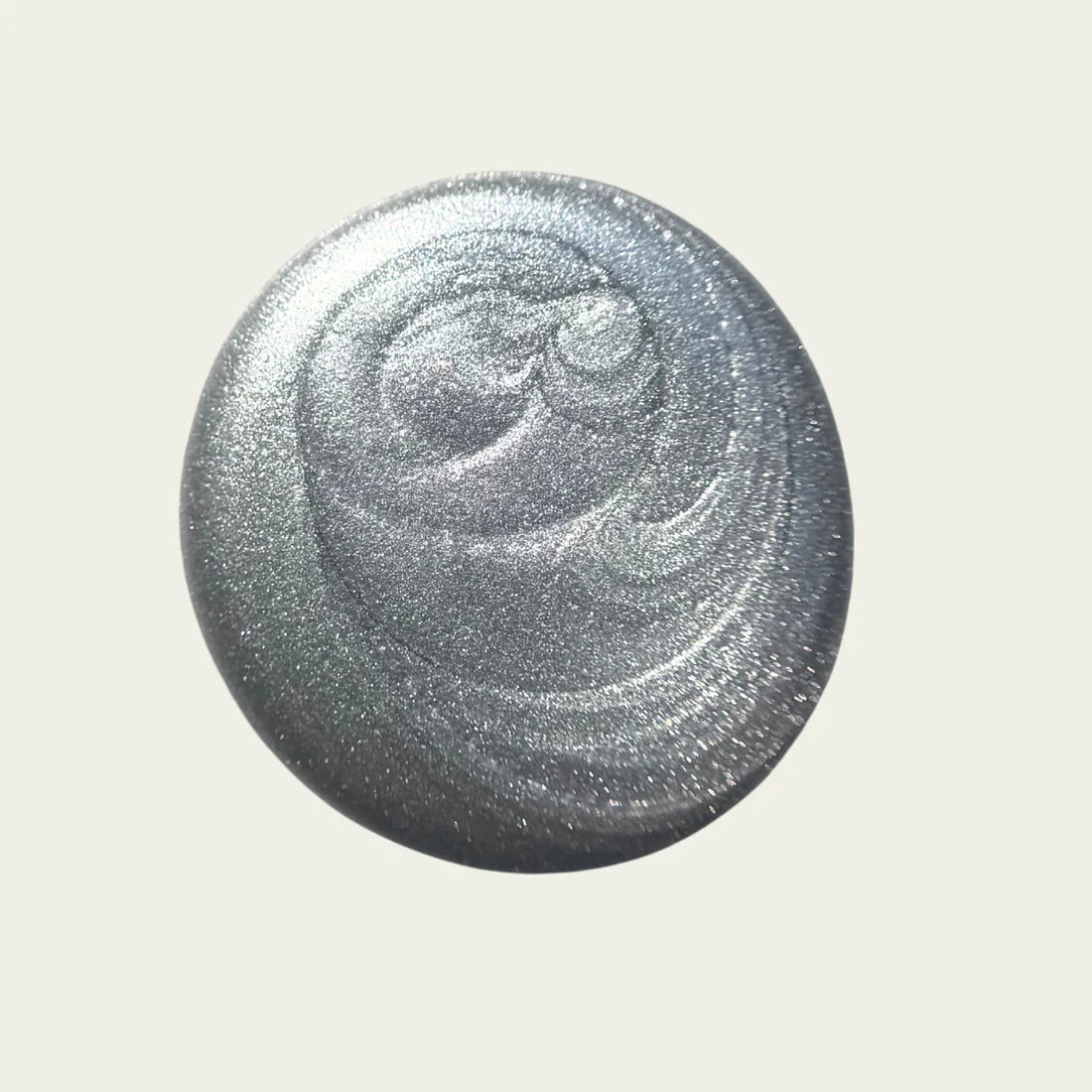 Silver glittery polish on a white background