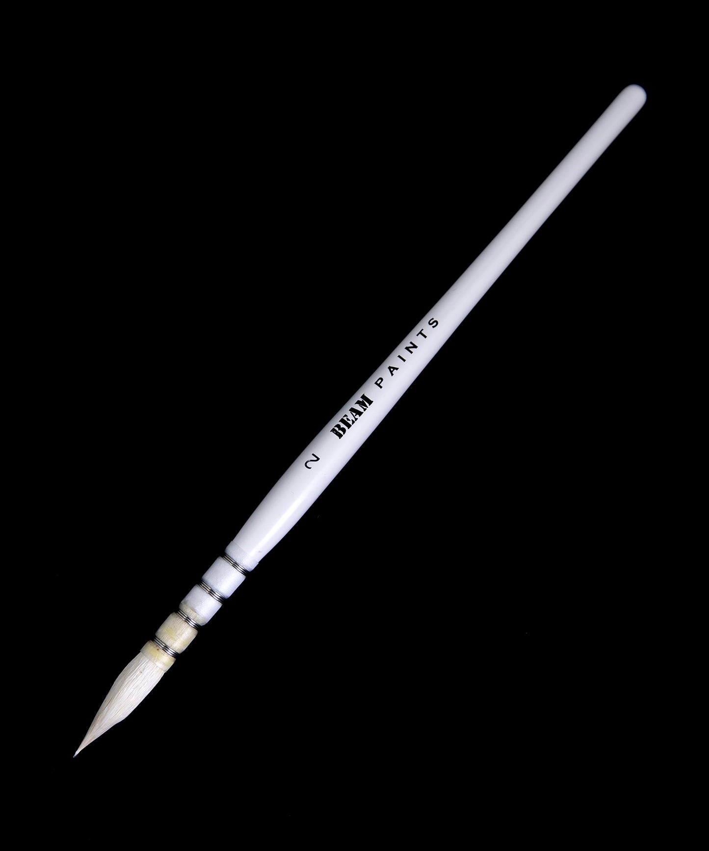 white paint brush with natural wool bristles on black background