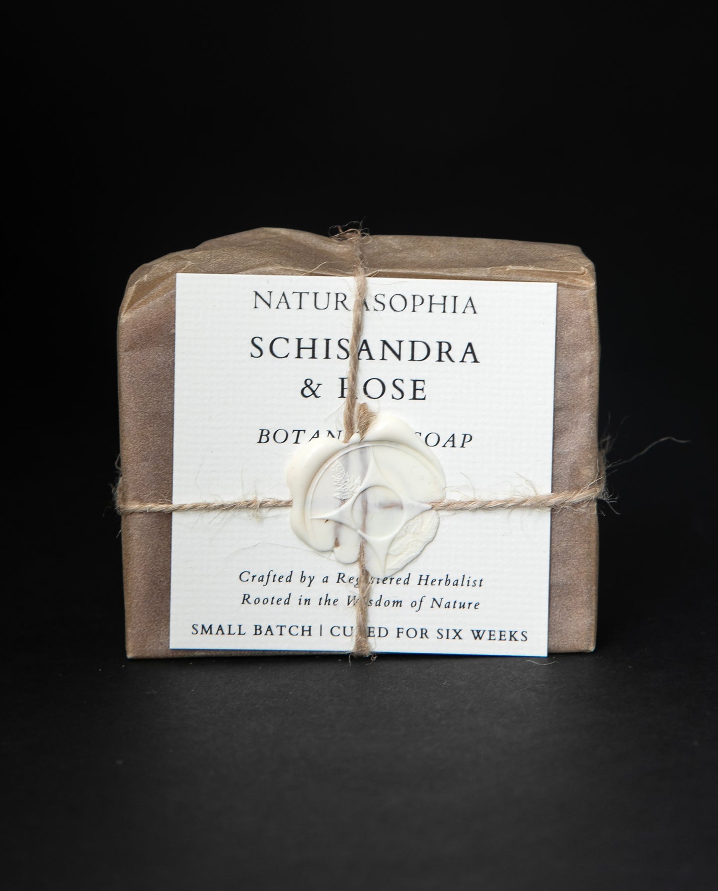 Bar of Naturasophia soap wrapped in brown paper and twine, with a label that reads