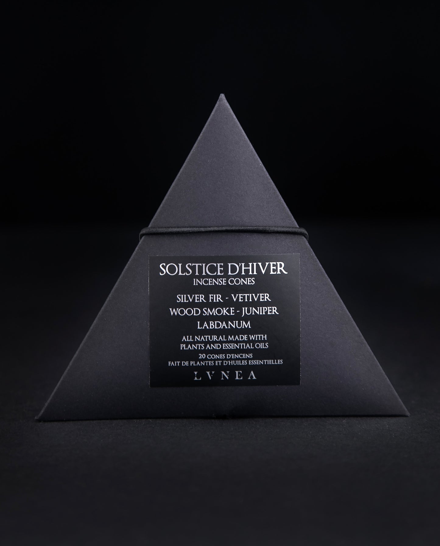 A closed black paper pyramid box of LVNEA's 'Solstice d'Hiver' incense. The black label on the box reads