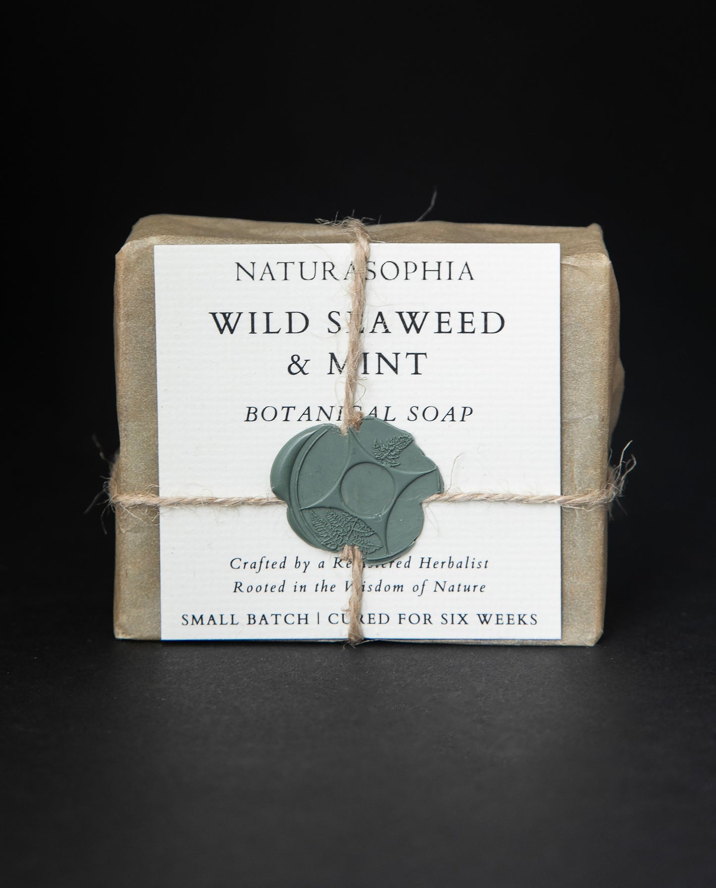 Bar of Naturasophia soap wrapped in brown paper and twine, with a label that reads