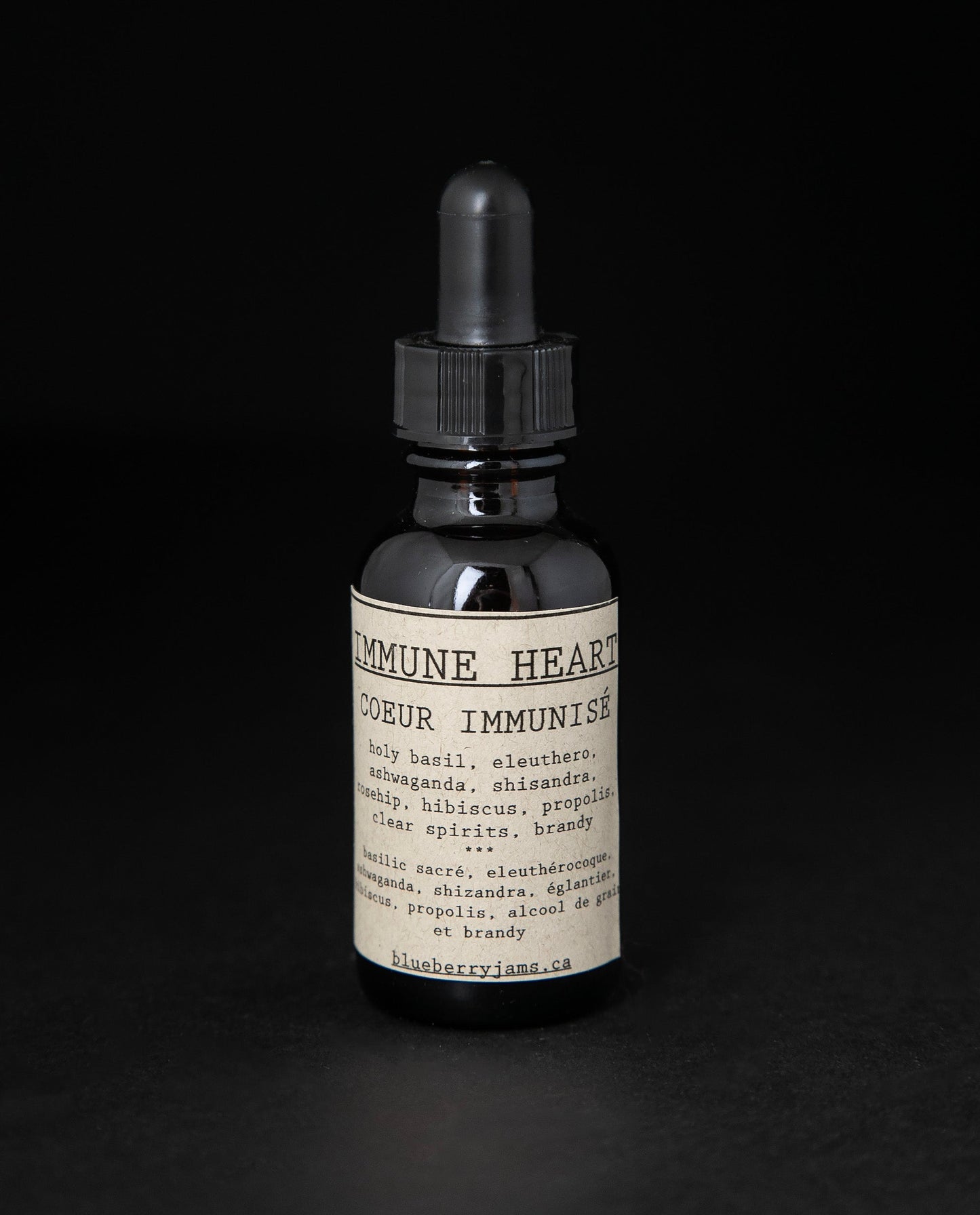 Black glass bottle with dropper top of blueberryjams