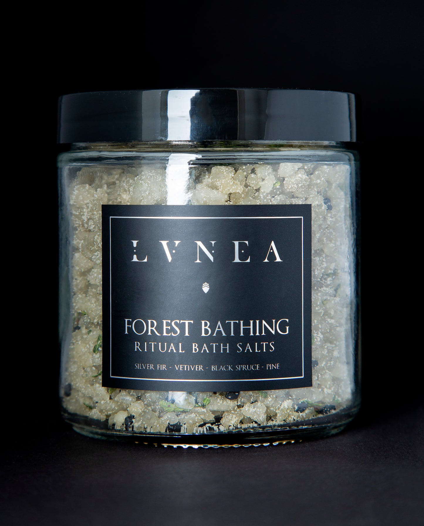 A clear 16 ounce jar filled with LVNEA's Forest Bathing bath salts on black background