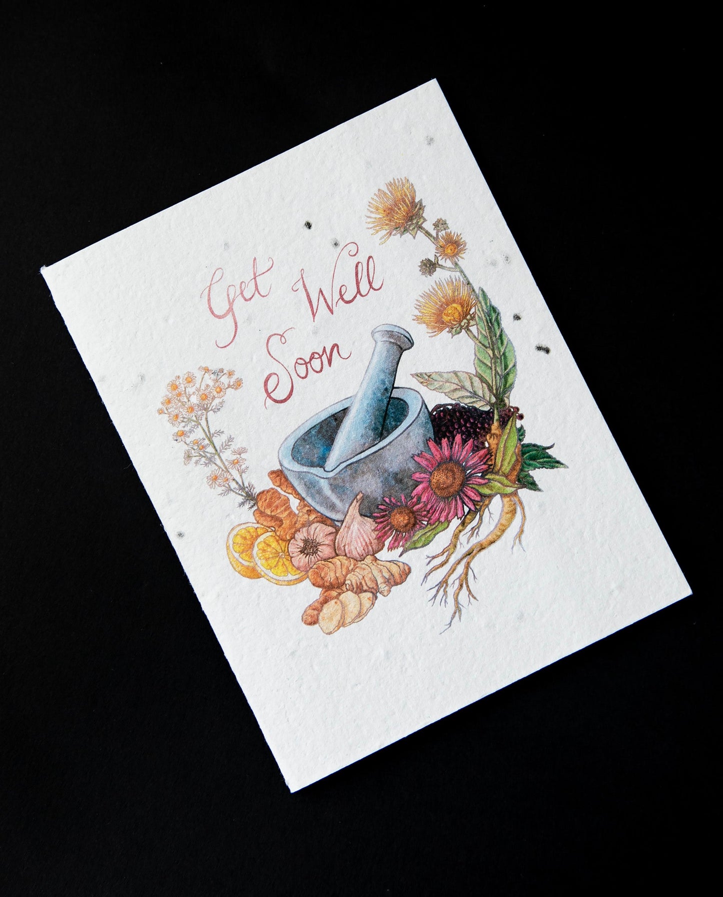 Cream coloured greeting card with illustration of a mortar and pestle surrounded by botanicals. The card reads