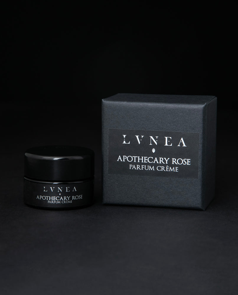 10g black glass jar of LVNEA's Apothecary Rose solid perfume, sitting next to its box on black background