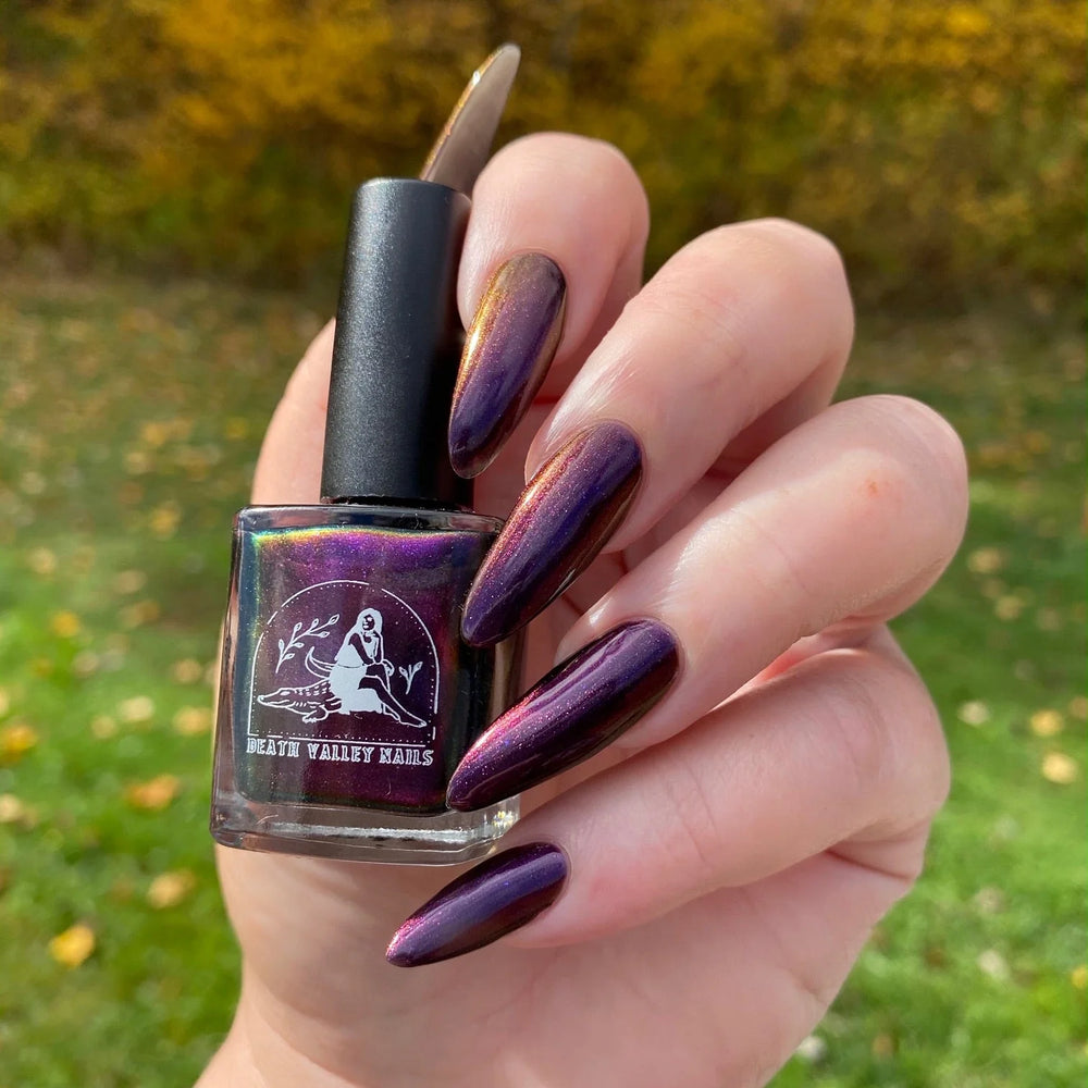 
                      
                        "Bat out of Hell" nailpolish shown on model. The natural light emphasizes the yellowy-orange reflections in the purple polish.
                      
                    