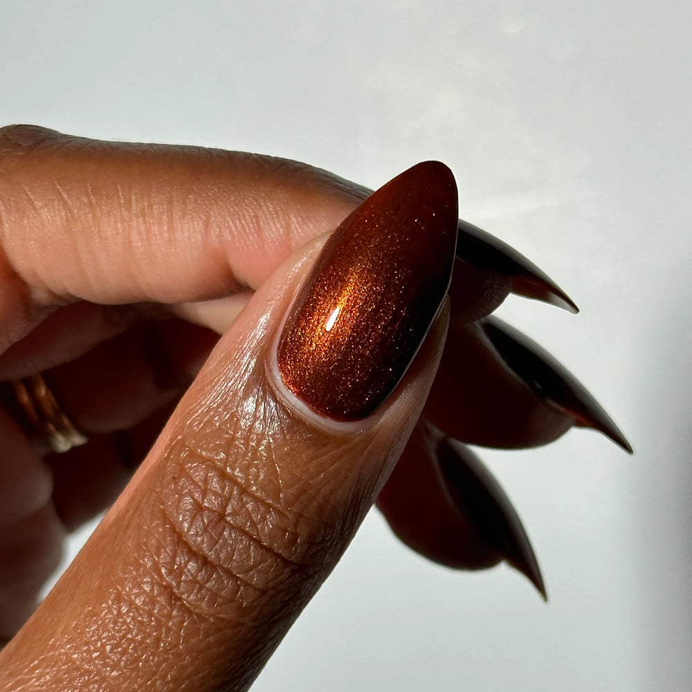 
                      
                        "Flying Mud Boat" nailpolish shown on model's hand.
                      
                    