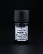 5ml black glass bottle of beeswax absolute on black background