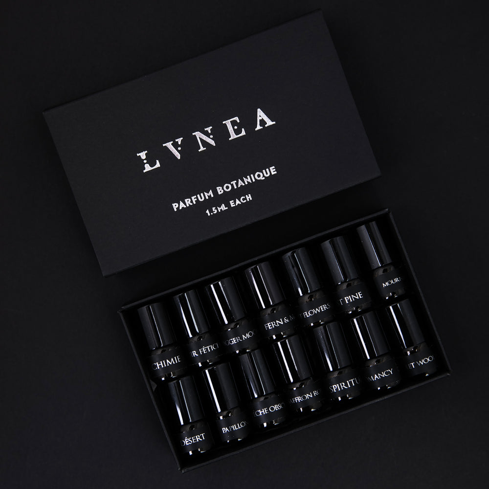black paper box containing LVNEA's full 14-piece parfum botanique sample set