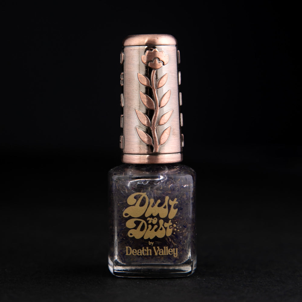 "Cornflower" nail polish by Death Valley Nails. The polish is clear with flecks of real cornflower petals.