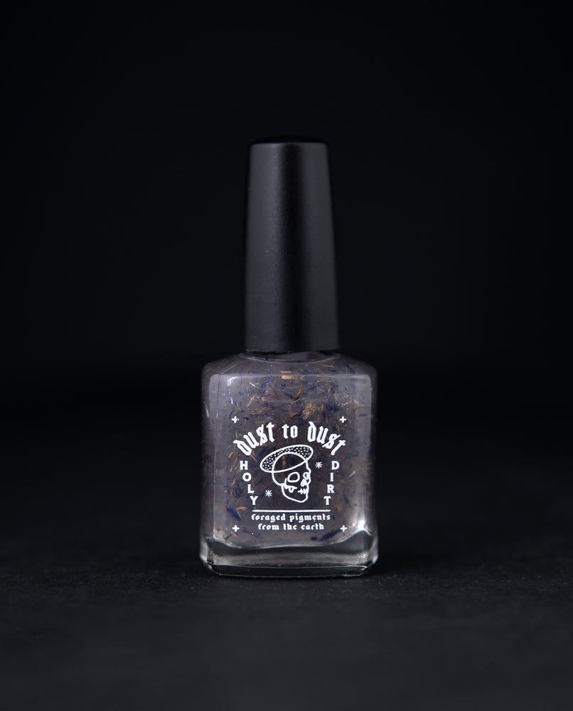"Cornflower" nail polish by Death Valley Nails. The polish is clear with flecks of real cornflower petals.