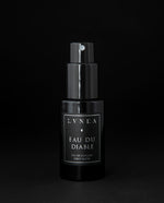 50ml black glass bottle of LVNEA’s Eau du Diable natural fragrance on black background