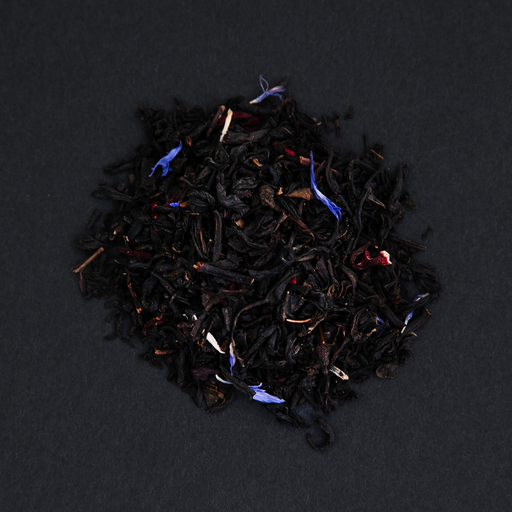 
                      
                        small pile of "eros" tea viewed from above against a black background
                      
                    