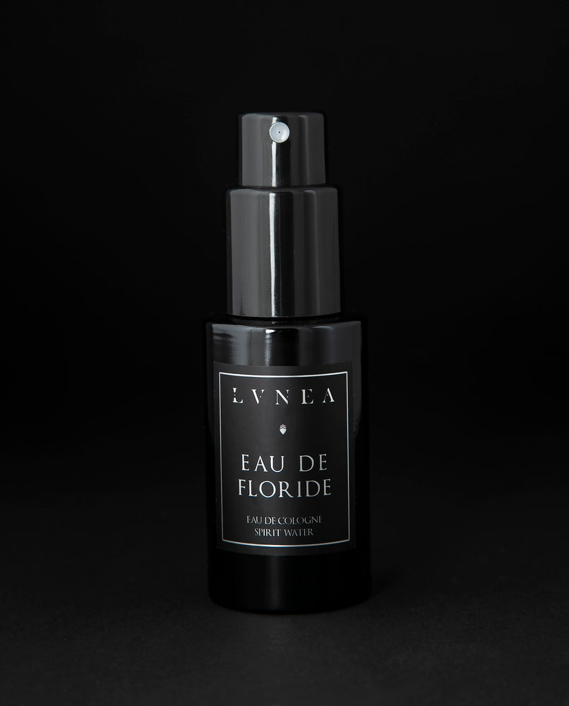 50ml black glass bottle of LVNEA’s Eau de Floride natural fragrance on black background