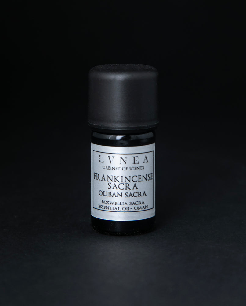 5ml black glass bottle with silver label of LVNEA's frankincense sacra essential oil on black background