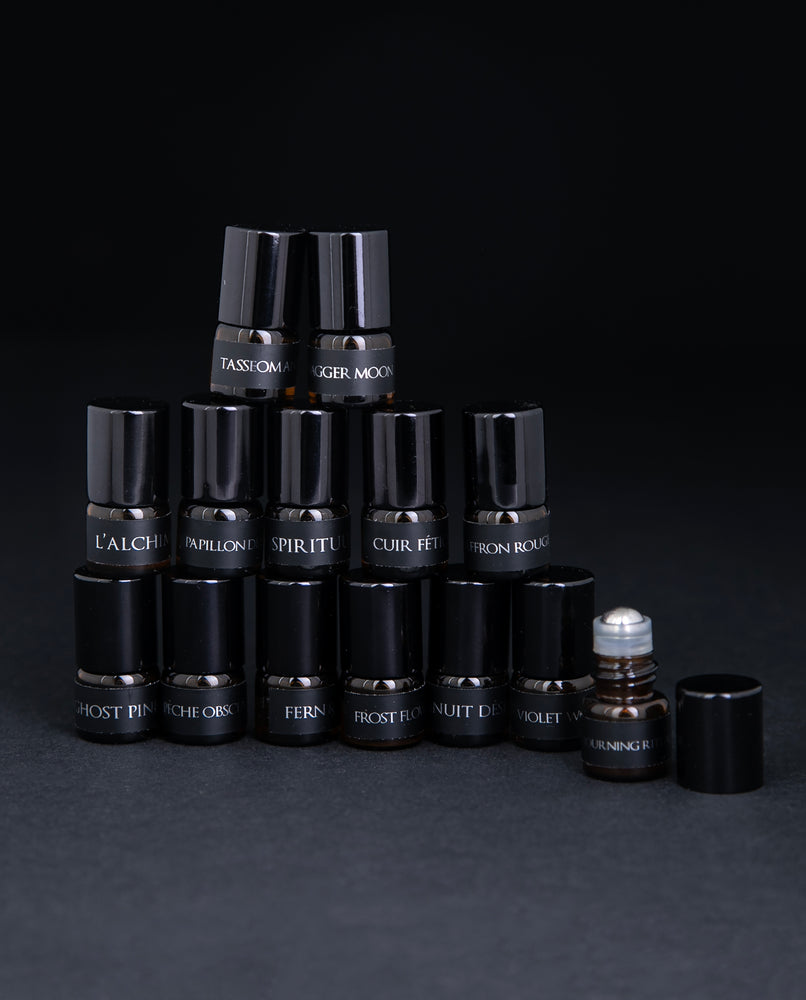 All 14 parfum botanique sample vials stacked up in a pyramid, against a black background.