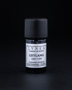 5ml black glass bottle of Lisylang essential oil on black background