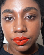 "Mortar and Pestle" brick red lip paint shown on model