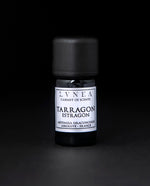 5ml black glass bottle of LVNEA's tarragon absolute on a black background. The label on the bottle is silver.