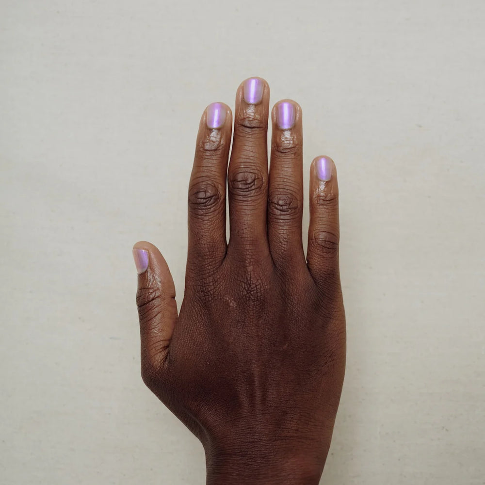 
                      
                        Hand with light purple nail polish on a plain background
                      
                    