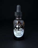 1oz amber glass bottle with black dropper top containing Fat and the Moon's "Anise and Clove Tooth Cleanse". 