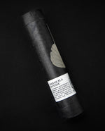 Black paper tube on black background. The label on the tube reads "Mahakala Incense".