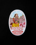 tin of rose flavoured bonbons with image of a woman in a rose field on the top