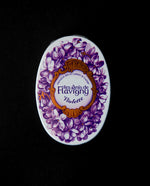 Closed tin of Anis de Flavigny bonbons. The lid is ornate and features illustrations of violet flowers.