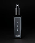 30ml black glass bottle of LVNEA’s Holy Oak natural perfume on black background. The lid is removed, exposing the bottle's spray top.