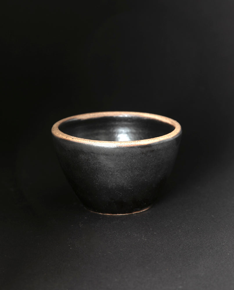 black stoneware bowl on black background