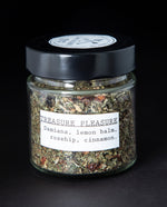 Clear glass jar of blueberryjams' "Treasure Pleasure" herbal tea blend.