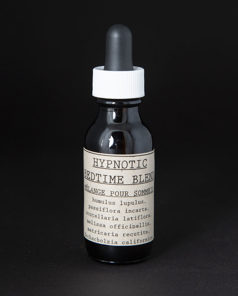 black glass bottle with dropper top and tan label on black background. The bottle contains a herbal tincture by blueberryjams