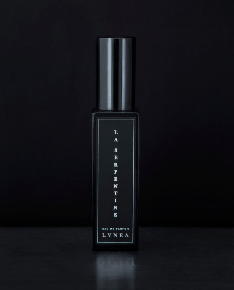 30ml black glass bottle of LVNEA’s La Serpentine natural perfume on black background