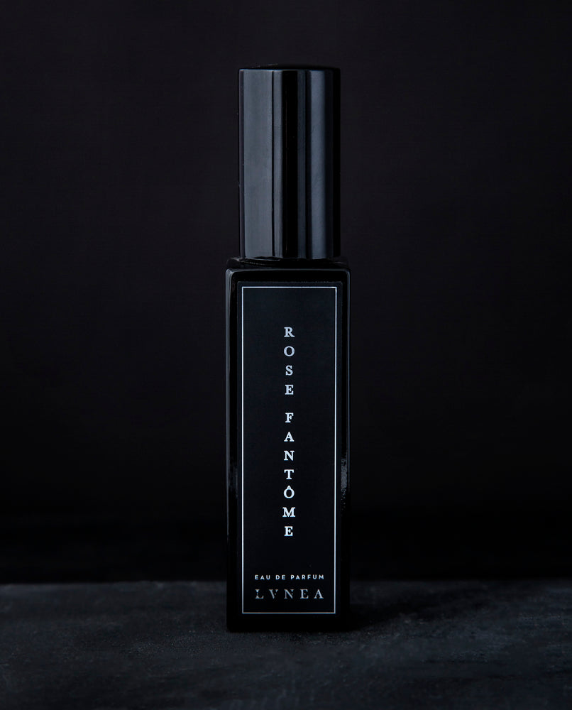 30ml black glass bottle of LVNEA’s Rose Fantôme natural perfume on black background