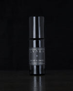 10ml black glass bottle of LVNEA's Frost Flowers natural roll on perfume on black background