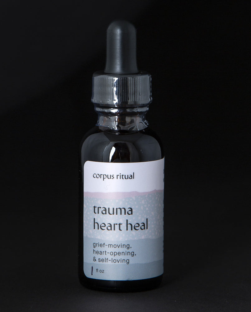 Black glass bottle with dropper top containing Corpus Ritual's "Trauma Heart Heal" herbal tincture.