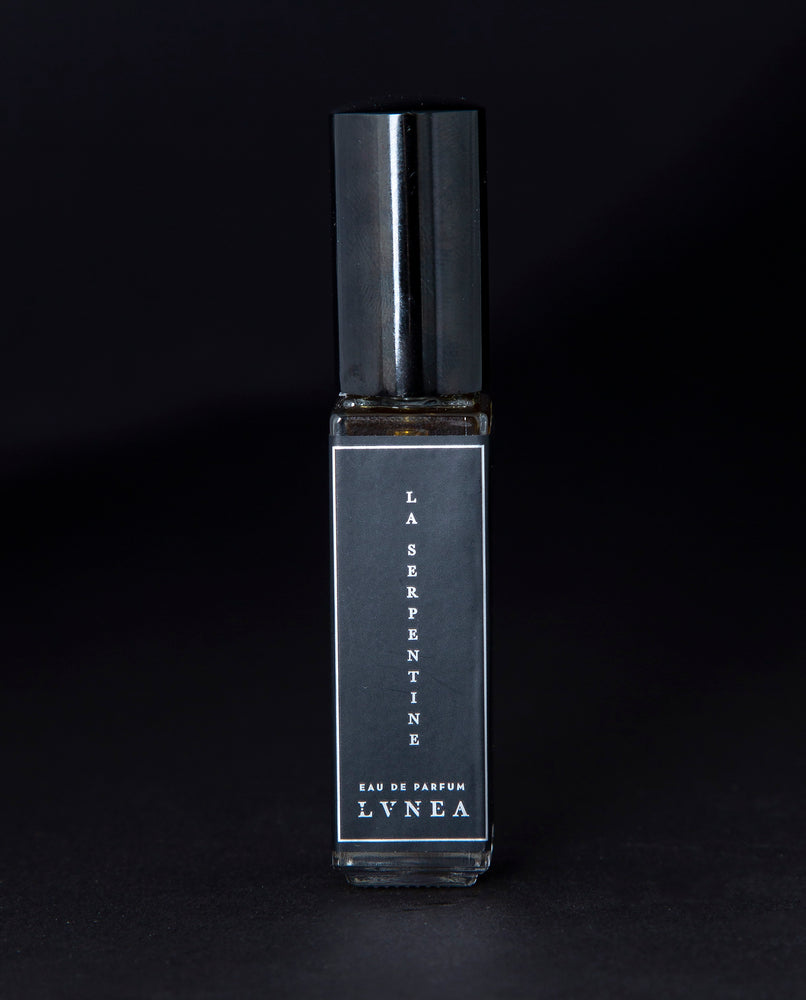 8ml clear glass bottle of LVNEA’s La Serpentine natural perfume on black background