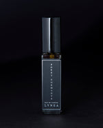 8ml clear glass bottle of LVNEA’s Forêt Dormante natural perfume on black background