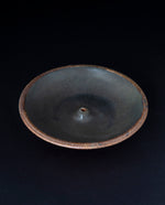 matte black glazed stoneware incense holder on black background