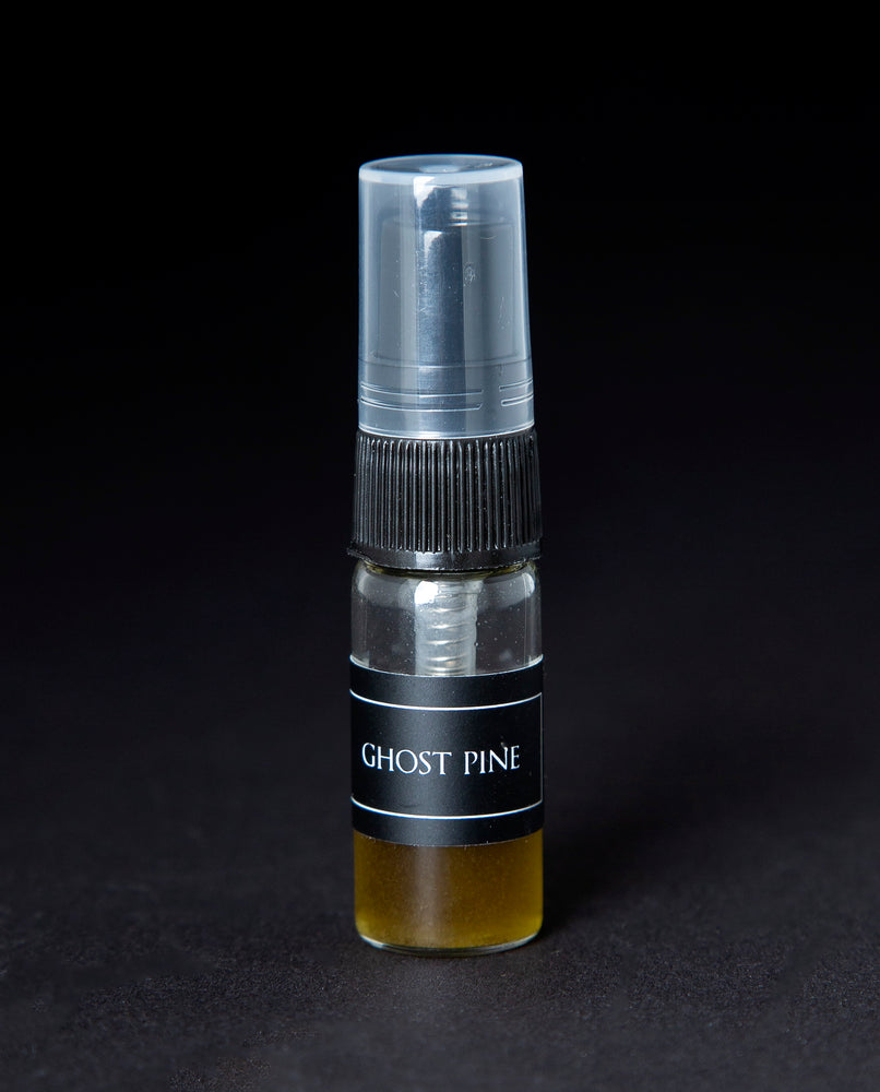 2.5ml sample bottle with spray top of LVNEA's Ghost Pine natural perfume on black background