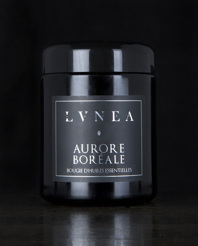 LVNEA’s Aurore Boréale candle housed in a resealable 8 ounce black glass jar on a black background