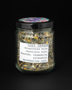 clear glass jar with black lid of blueberryjams' "Cozy Dragon" herbal tea blend