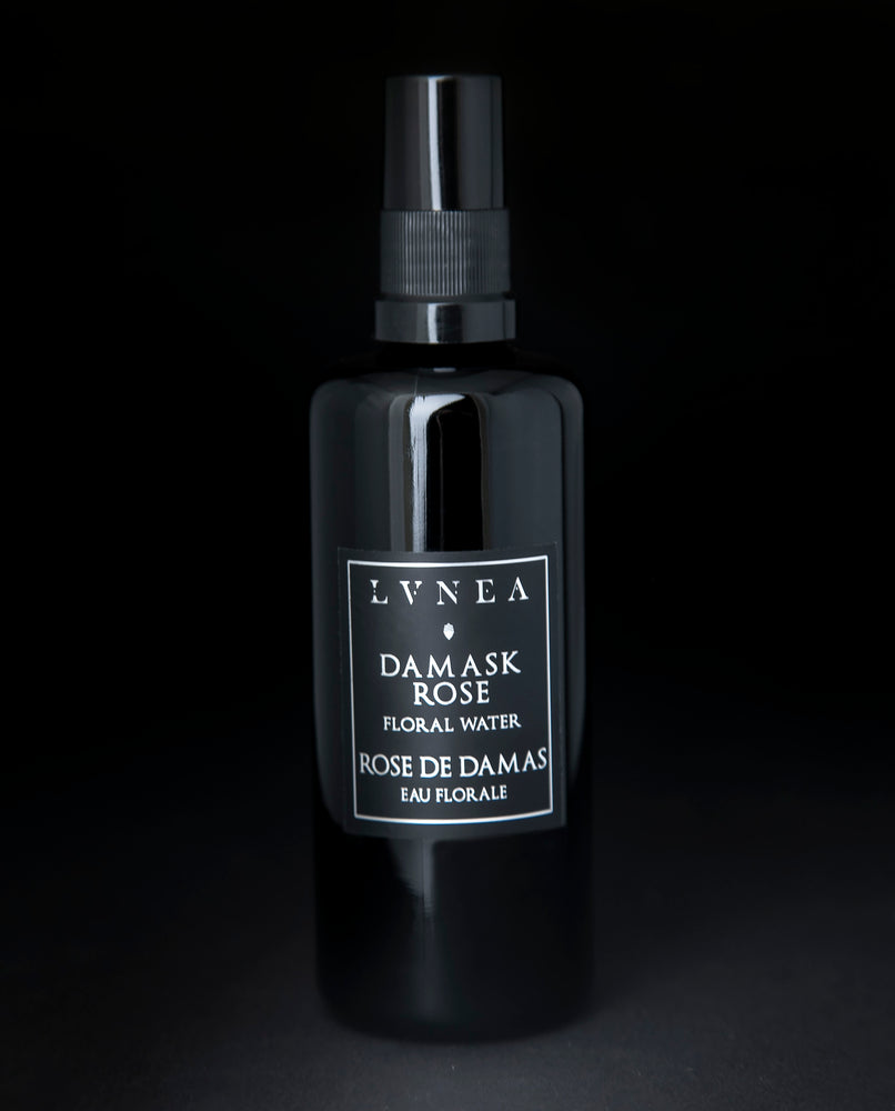 100ml black glass bottle of LVNEA's Damask Rose Hydrosol on black background