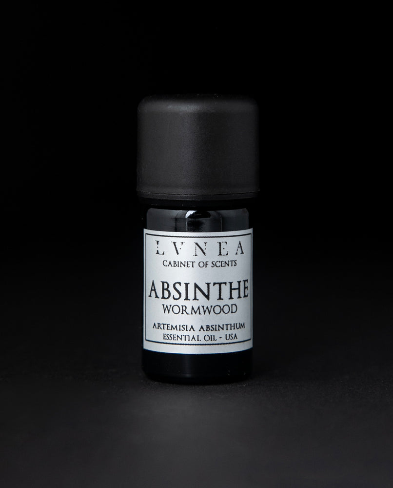 5ml black glass bottle with silver label of LVNEA's absinthe essential oil on black background.