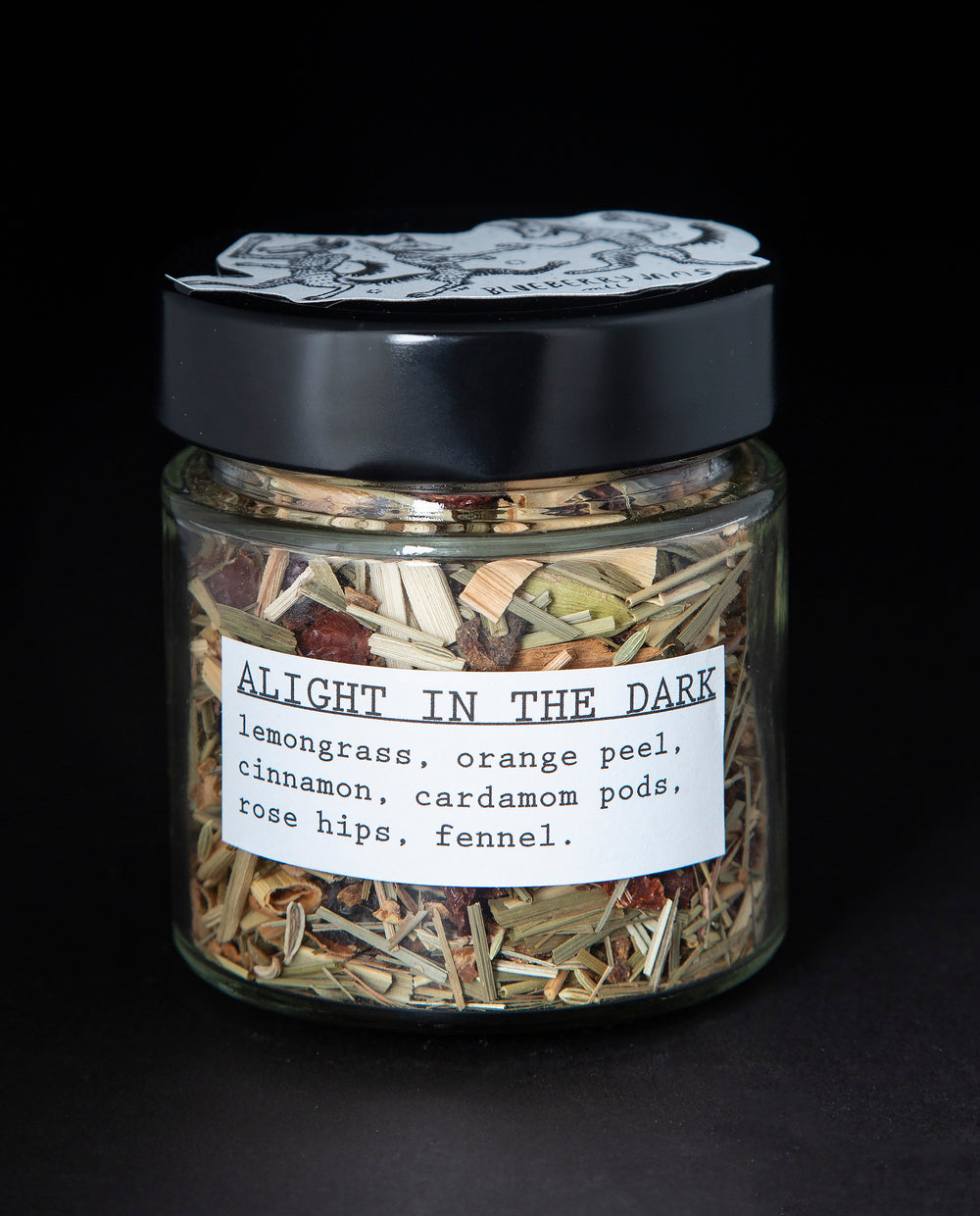 Clear glass jar with black screw on top containing blueberryjams' 