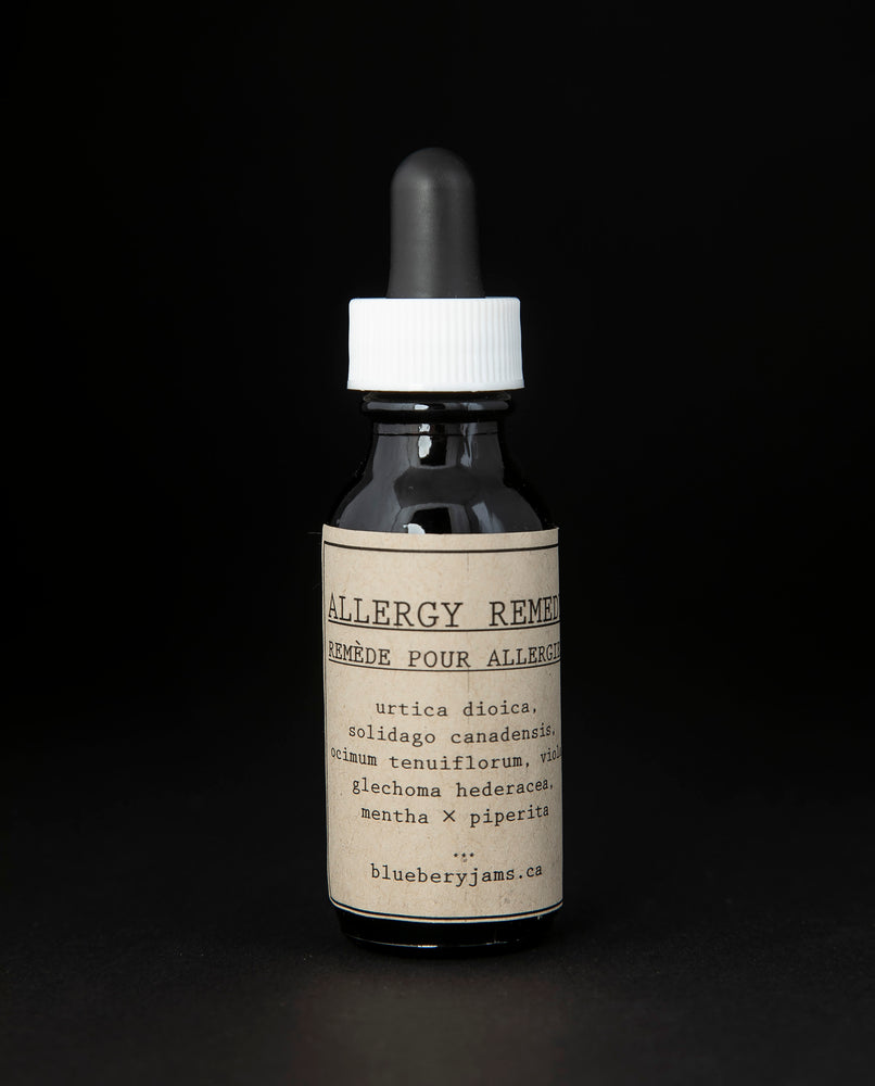 Black glass bottle with kraft paper label and dropper top. Contains blueberryjams' "Allergy Remedy" tincture