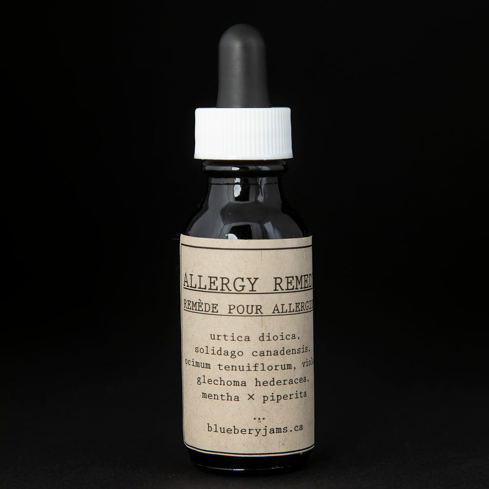 Black glass bottle with kraft paper label and dropper top. Contains blueberryjams' "Allergy Remedy" tincture