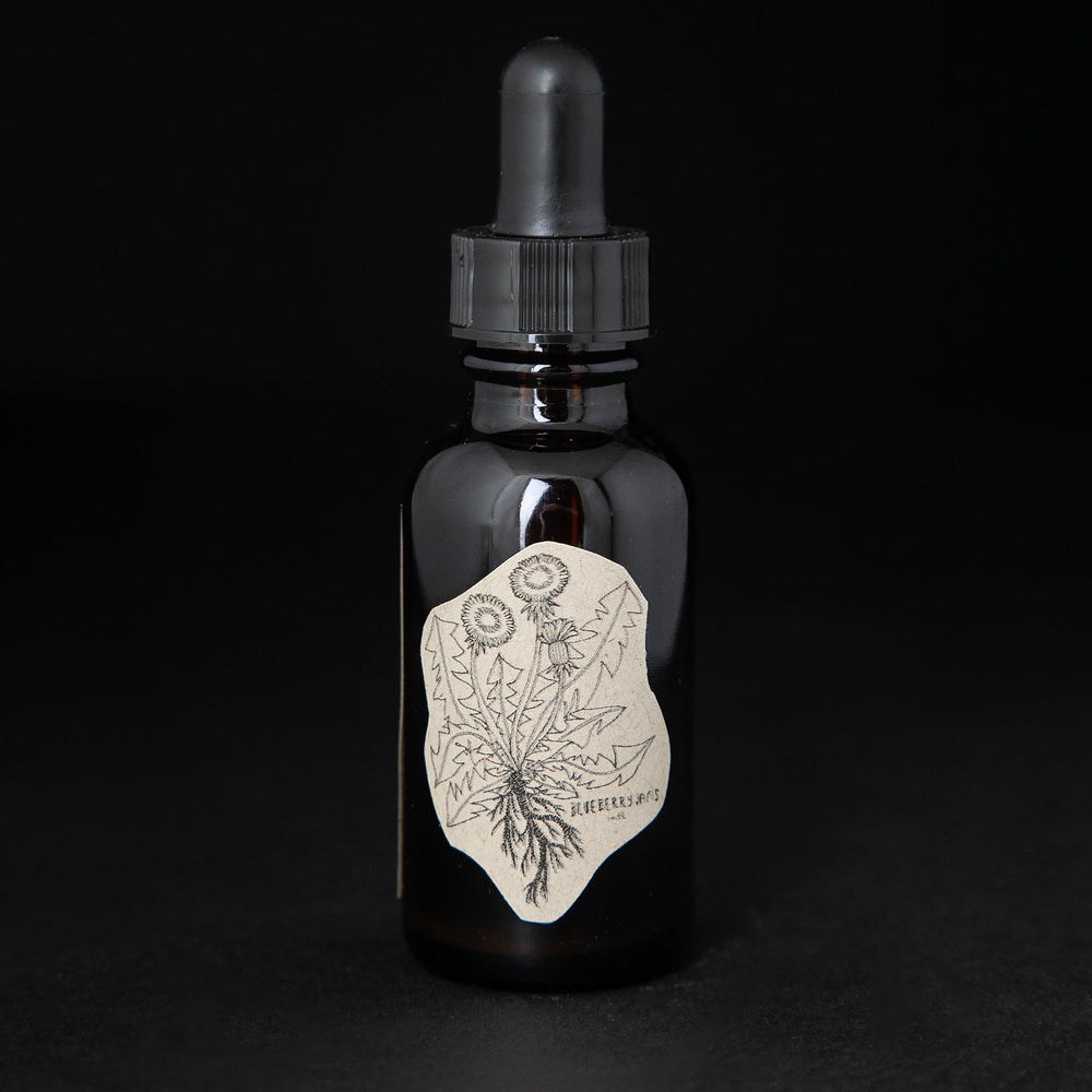 Black glass bottle with dropper top and label featuring a simple line drawing of a dandylion. The bottle contains a herbal tincture by blueberry jams.