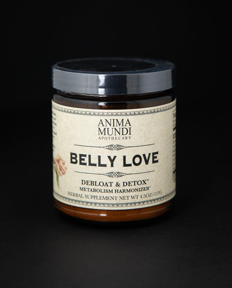 4.5oz amber glass jar with black lid of Anima Mundi's "Belly Love" herbal supplement. The tan label on the jar reads "debloat & detox, metabolism harmonizer"