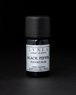 5ml black glass bottle of LVNEA's black pepper essential oil on black background. The label on the bottle is silver.